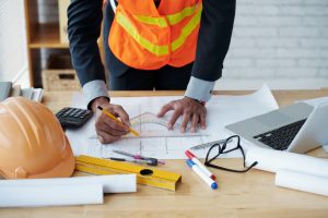 Architect planning project with blueprints